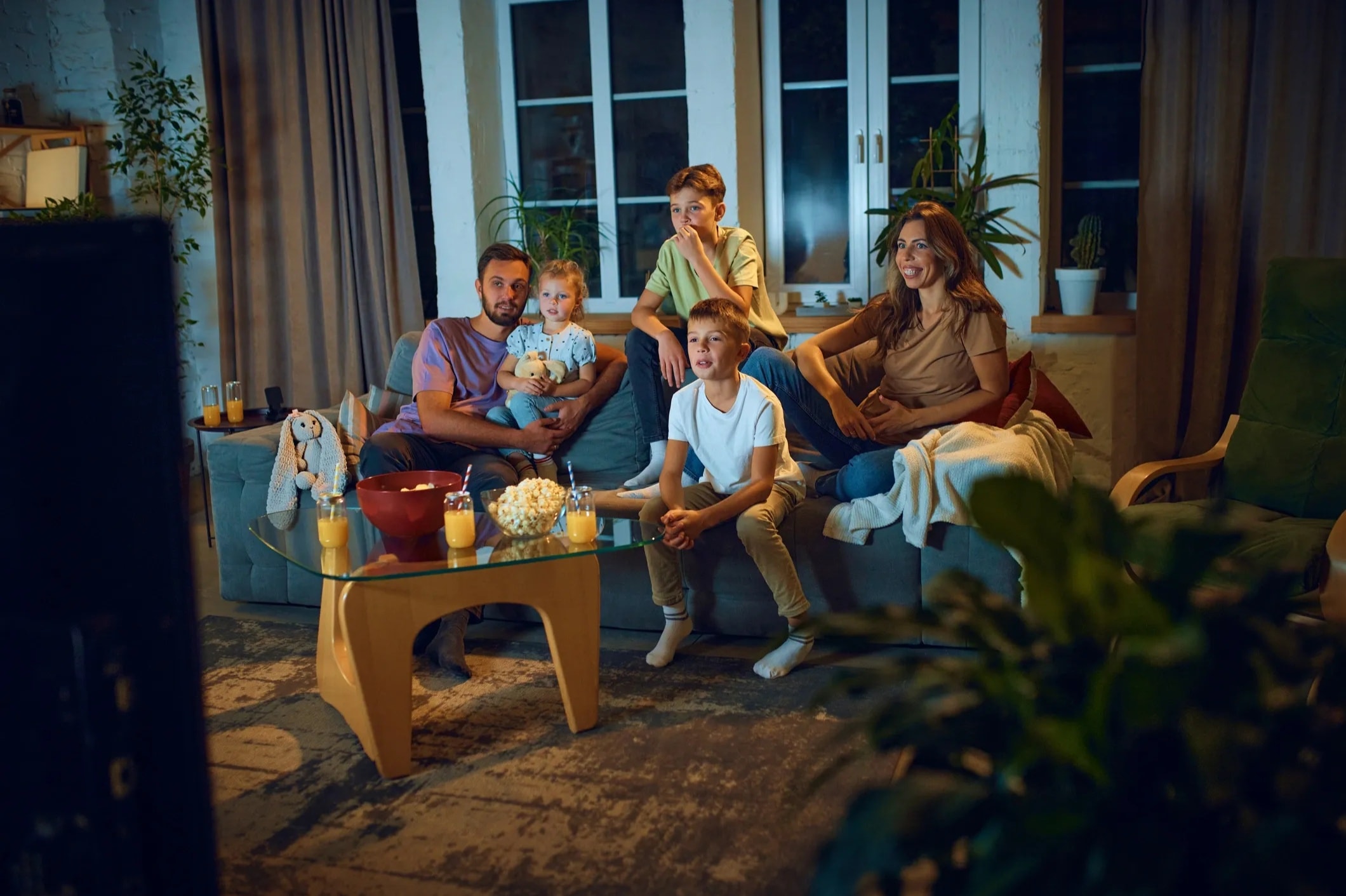 A family gathered together for a film night at home